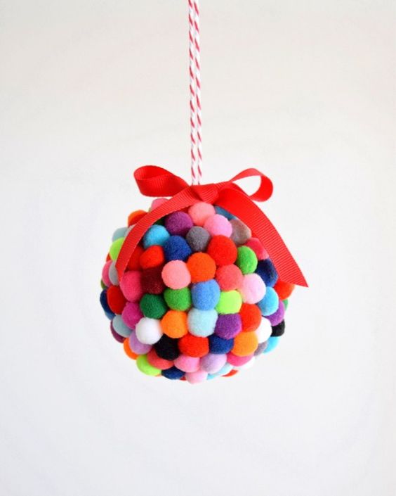 a colorful small pompom ornament with a bow on top is a fun idea to decorate your Christmas tree a colorful small pompom ornament with a bow on top is a fun idea to decorate your Christmas tree
