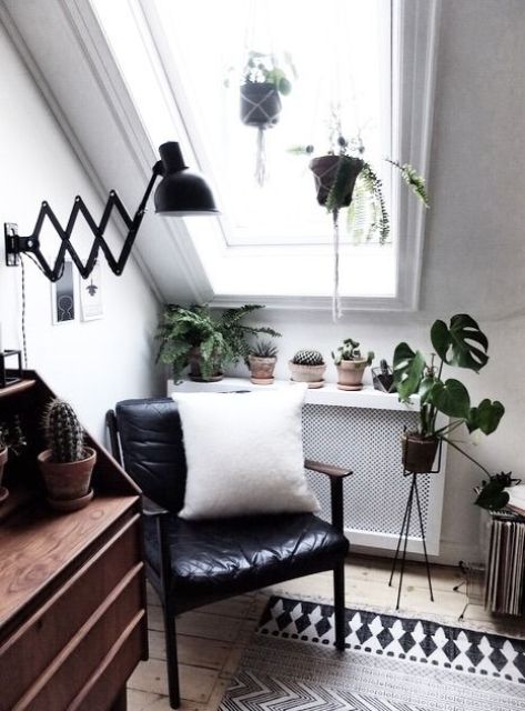 a cozy reading corner with a leather chair, a sideboard and a classic sconce, which can be regulated