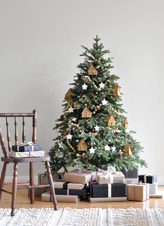 a cozy Christmas tree with wooden bead garlands, wooden tree ornaments and pinecones plus lights all over