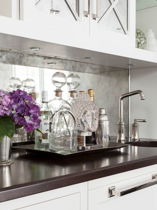 an antique mirror backsplash will reflect light and make your home bar stunning and catchy