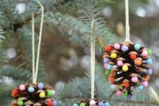 14 take large pinecones and glue some colorful pompoms to them – these are fun and natural Christmas decorations