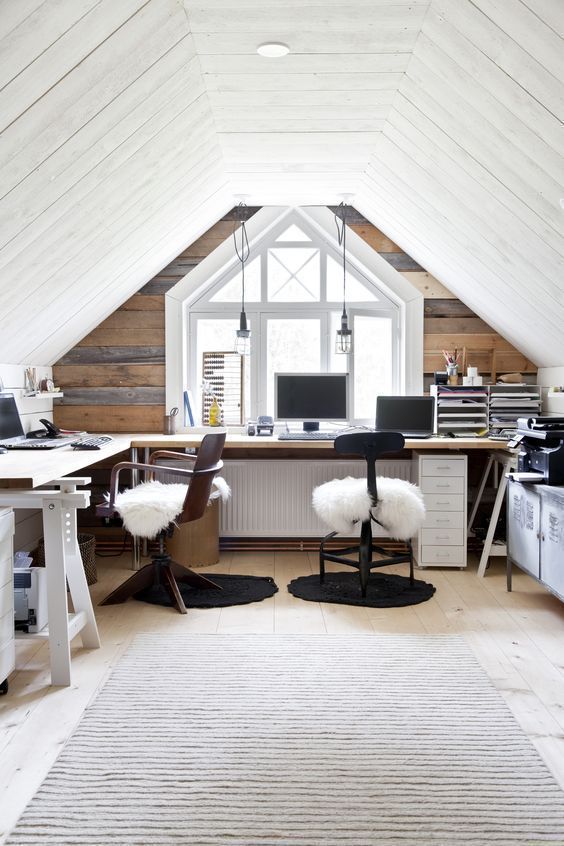 a shared home office in neutrals with a reclaimed wood wall and a rug to add texture