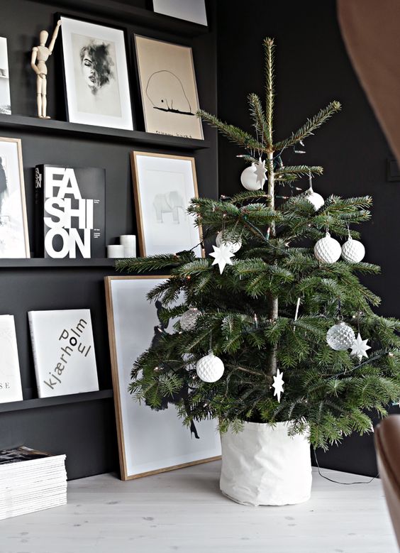 a small Nordic Christmas tree with ball and star-shaped ornaments, clear and white ones