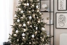 16 a Scandinavian Christmas tree decorated with white ball and star ornaments, metallic ornaments plus lights in a basket