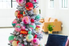 16 a silver Christmas tree decorated with colorful oversized pompoms for a bold statement