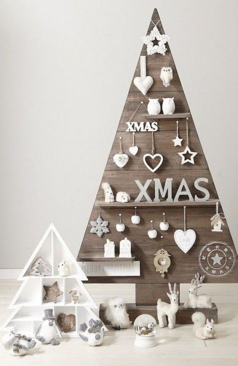 a plywood Christmas tree with hooks and shelves and all kinds of decorations located on them