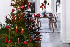 18 a cute traditional Christmas tree with red ornaments and real candles plus a white star topper