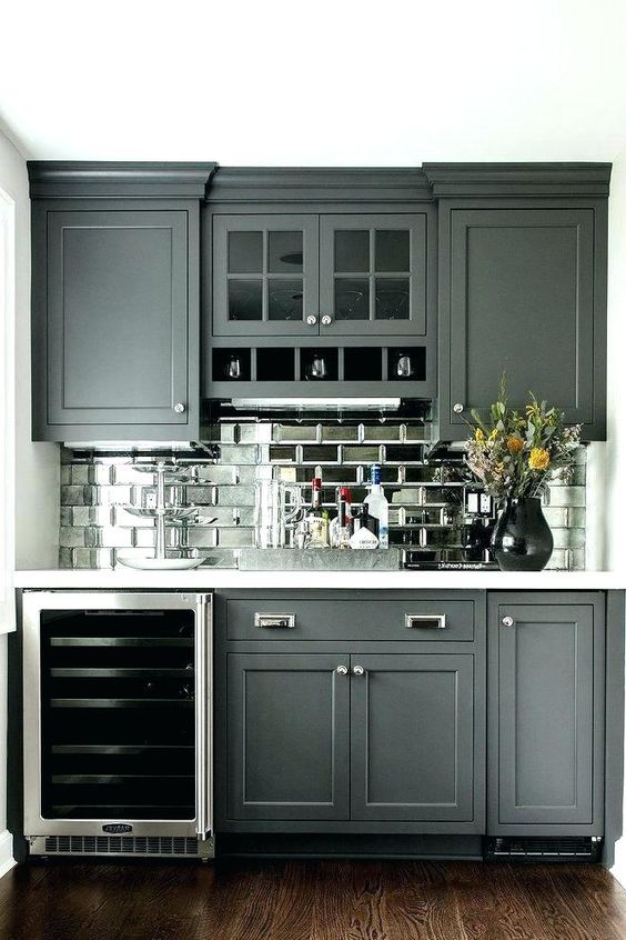 a graphite grey farmhouse kitchen with a mirror tile backsplash to add a touch of shine