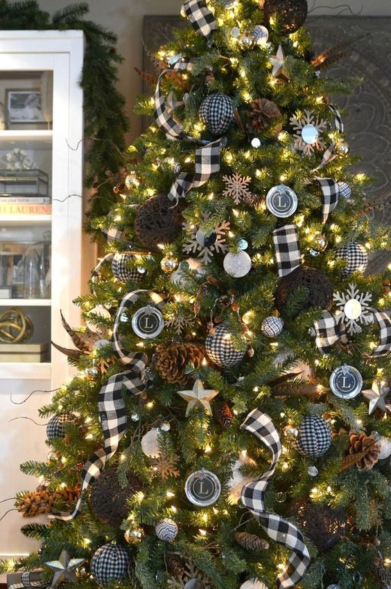 a rustic meets traditional Christmas tree with plaid ornaments and ribbons, pinecones and vine balls