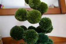 21 a fun green pompom Christmas tree made on wire with a gold felt star on top is a great alternative to a usual tree