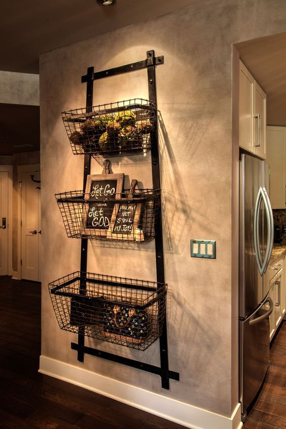 an industrial shelving unit made of metal strips and metal wire baskets in the entryway