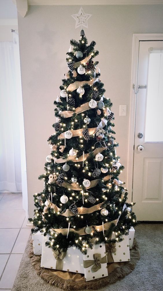 a rustic glam Christmas tree with white and silver ornaments, pinecones, icicle ornaments and lights