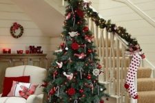 25 a traditional Scandi Christmas tree with red and white ornaments and candy canes hanging on the tree