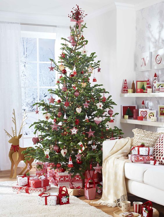 a traditional Scandinavian Christmas tree with various red and white ornaments and plaid decorations