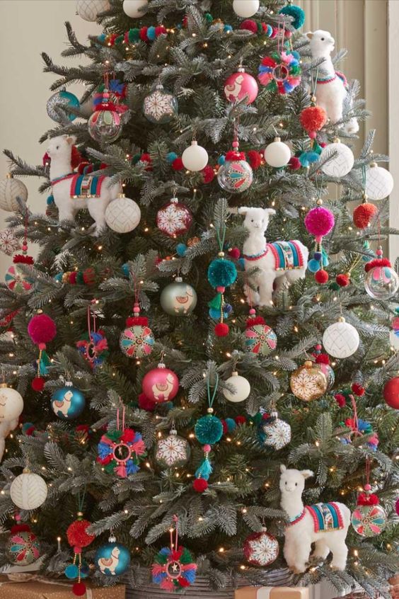 a Christmas tree decorated with colorful ornaments, pompoms and lights and some alpacas is a cool idea