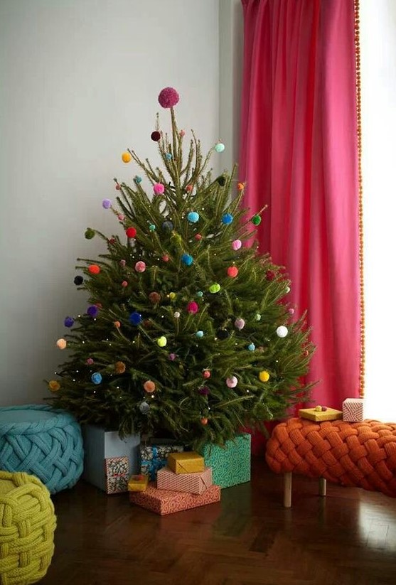 a Christmas tree decorated with colorful pompoms all over is a veyr fun and cool idea that won't cost you anything