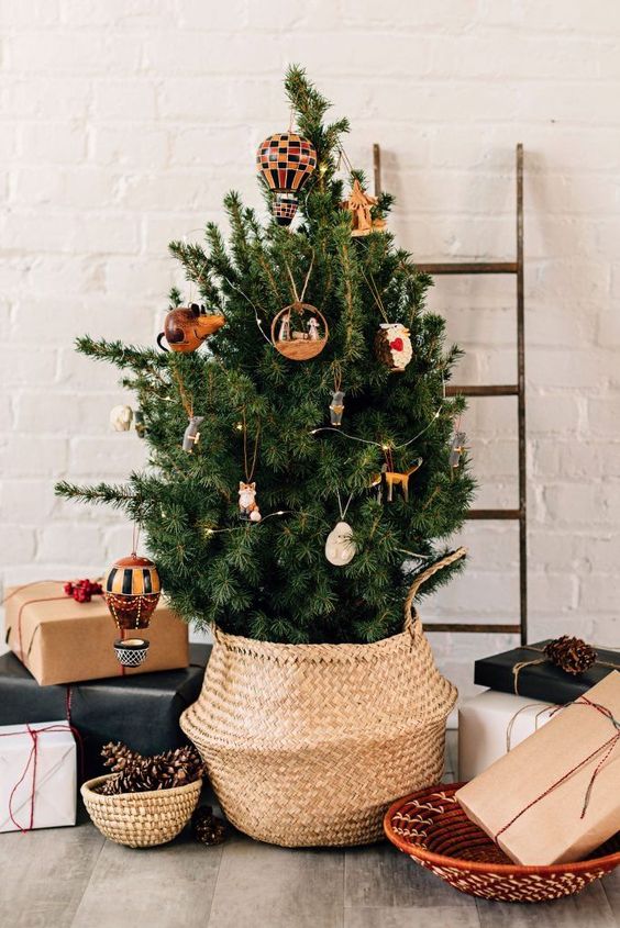 a Christmas tree with little whimsical ornaments and some lights is a cool idea for a modern space