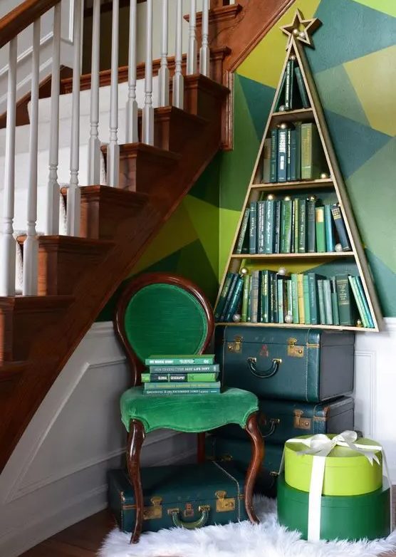 a bookshelf shaped as a Christmas tree, green books inside make it look more like a real Christmas tree