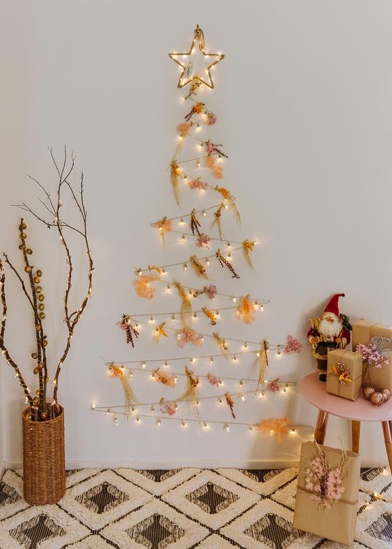 a catchy light wall-mounted holiday tree with colorful dried flowers and a star is amazing for Christmas