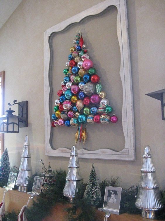 a colorful Christmas tree composed of ornaments attached to the wall and with a frame around for a chic look