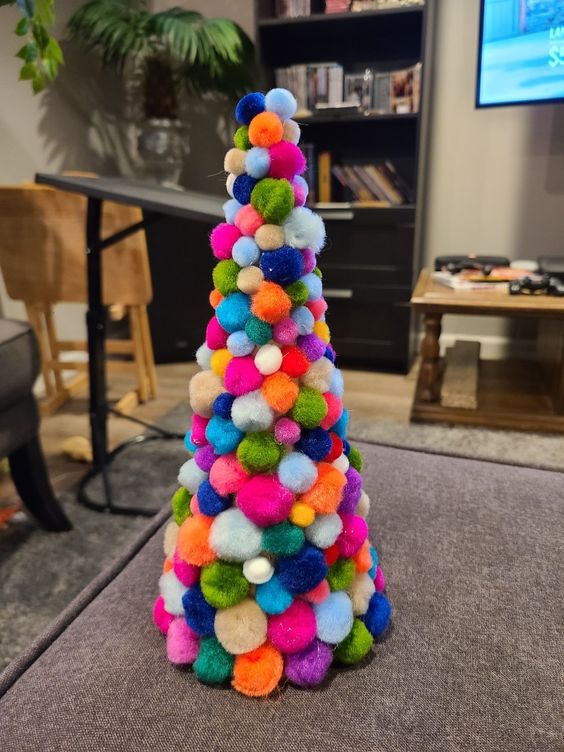 a colorful pompom cone-shaped Christmas tree is a nice decoration for any Christmas space