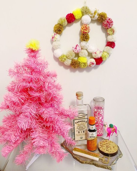 a colorful pompom wreath for boho Christmas decor is a cool and easy craft for winter holidays