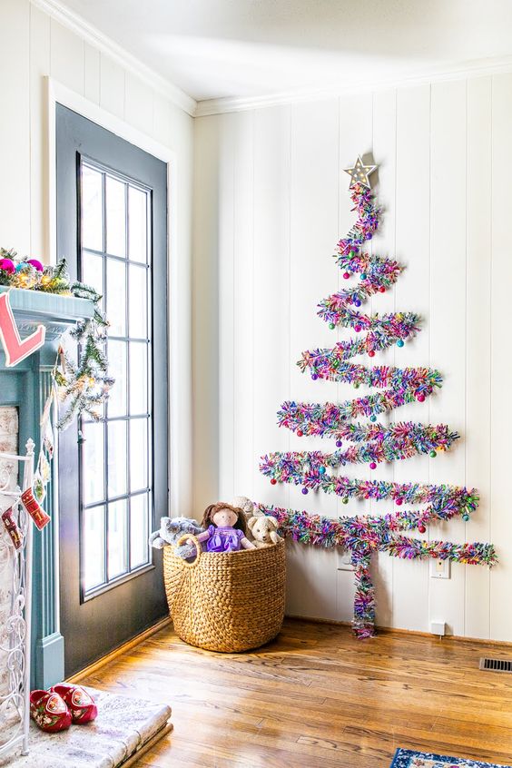 a colorful tinsel wall-mounted Christmas tree can be created on the wall in any space, for example, in an entryway