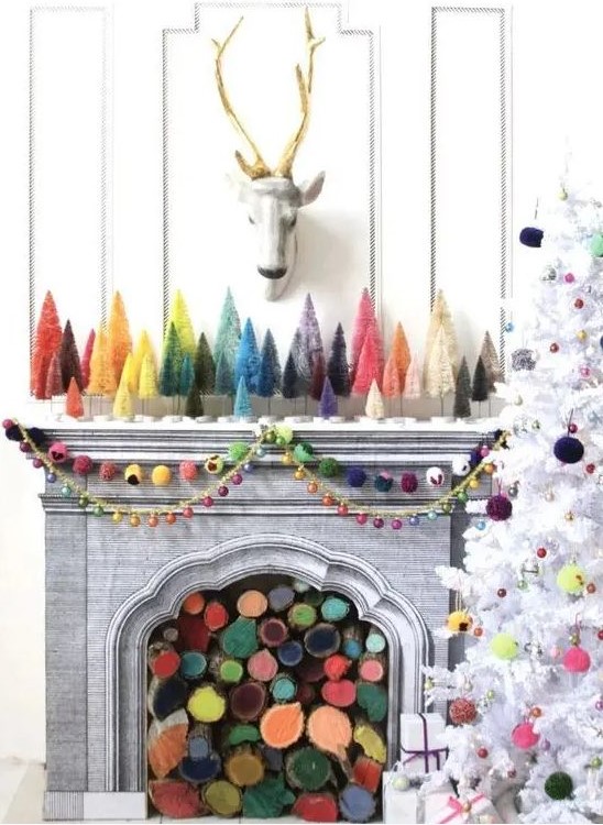 a fireplace filled with colorful firewood and matching bright bottle brush trees plus colorful felt garlands and bright pompoms on the tree