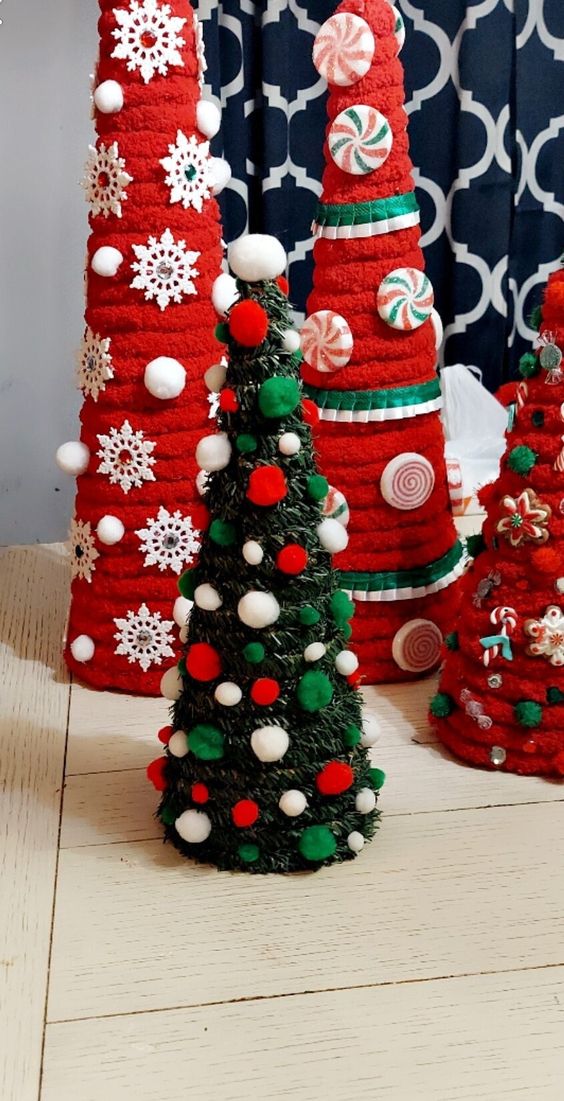 a green cone-shaped Christmas tree with colorful pompoms covering it is a cool tabletop Christmas decoration
