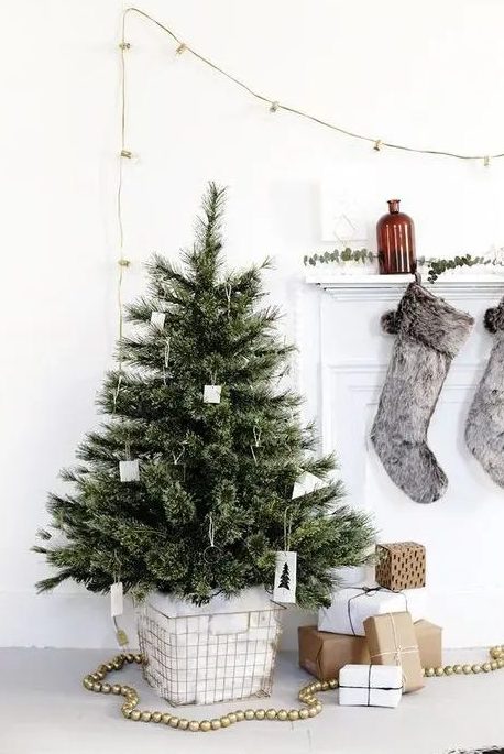 a modern Nordic Christmas tree with simple cardboard ornaments and metal wire ornaments that can be easily DIYed