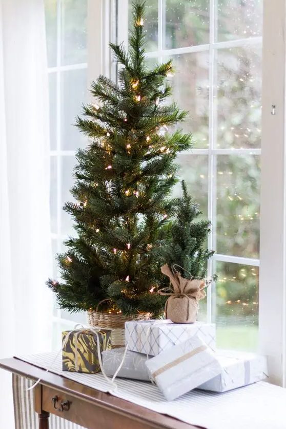 a modern tabletop Christmas tree decorated only with lights and nothing else is a very chic and cool solution