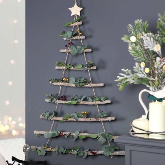 a natural wall-mounted Christmas tree of branches and rope, with eucalyptus and berries is a lovely idea