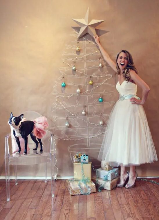 a painted Christmas tree with beads and bold Christmas ornaments, a large star tree topper and gift boxes that match