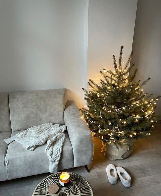 a small Christmas tree with only lights and nothing else looks very festive and cool and brings a holiday feel to the space