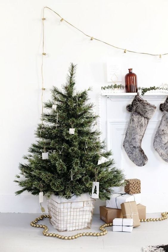 a small Christmas tree with white ornaments and no other decor is a perfect solution for a minimalist space