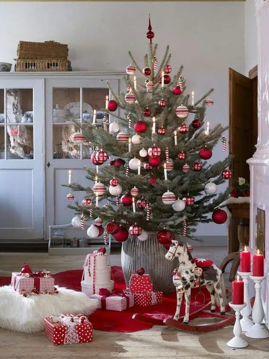a traditional Nordic Christmas tree with white, red and silver ornaments and candy canes as decorations