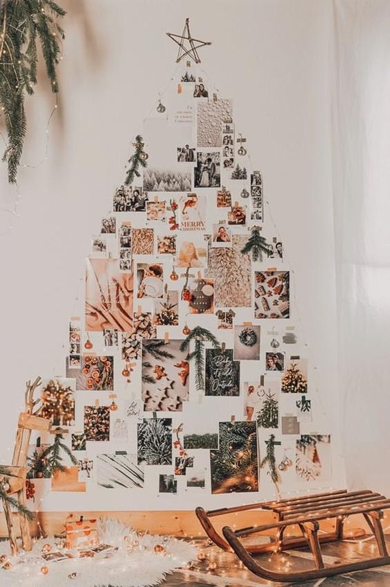 a wall Christmas tree composed of photos and evergreens is a lovely idea for a boho space
