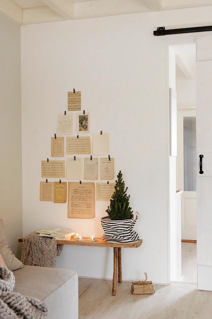 a wall Christmas tree composed of vintage book pages is a very creative solution, great for the holidays