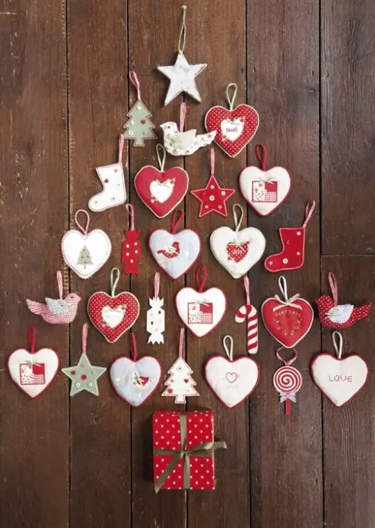 a wall-mounted Christmas tree composed of heart, star and tree ornaments in red and white, is amazing