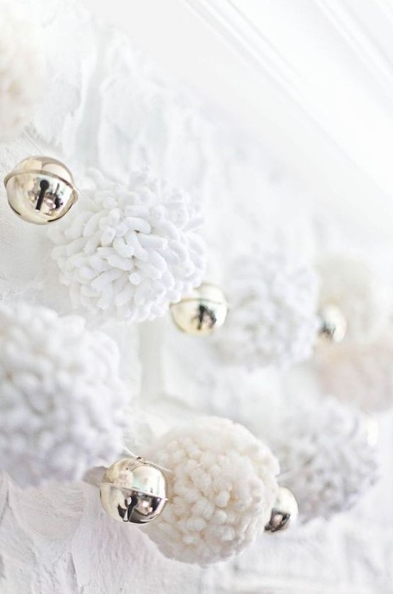 white pompom garlands with bells are very cozy and refined decorations for Christmas