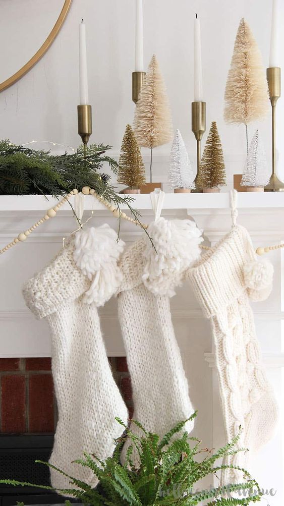 white stockings decorated with pompoms can accent your mantel, they will add interest to any space