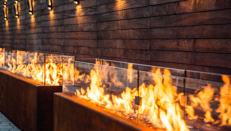 modern fire pit for a modern outdoor space The fire pit is long and can be used as a space divider or an accent as it has a strong visual impact