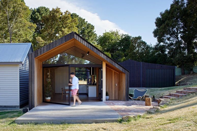 The house features a creative geometric shape and an outdoor deck in front of the house to enjoy fresh air