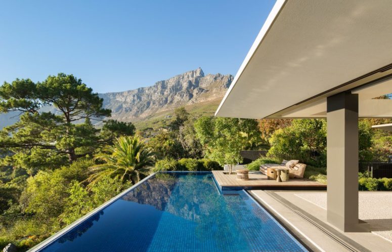 There's a large pool with a deck and the back of the house is fully opened to the surroundings