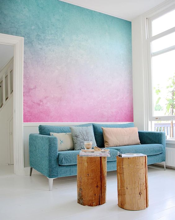 a bright turquoise to pink gradient wall is a gorgeous statement in the space, it brings much color