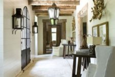 02 white wooden walls, a tiled floor, a wooden ceiling and beams make up a vintage Mediterranean space