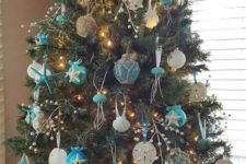 03 a bold beach Christmas tree with blue and white ornaments styled as floats and shells plus twine balls