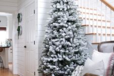 03 a flocked Christmas tree with no decor in a crate is a great idea for any entryway, add some candles around