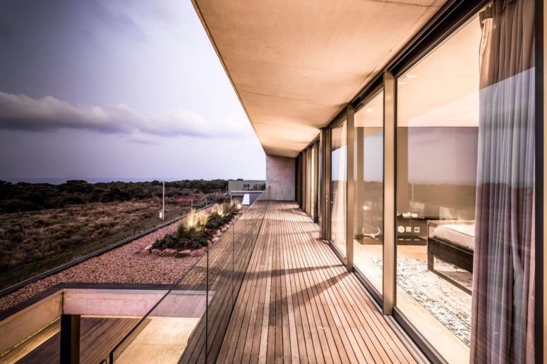 The house features glass walls, sliding doors and timber screens for increased privacy and comfort