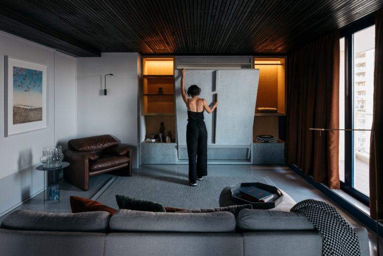 The living room is done with much storage space, with comfortable furniture and a large window with views